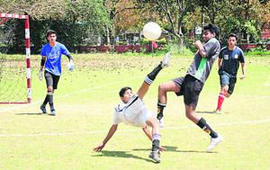 A Tribune Football Club player attempts an overhead kick in a match at Sector 17, Chandigarh