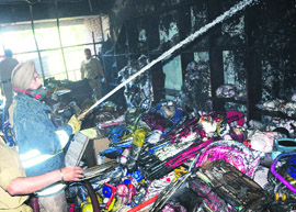 Fire officials try to douse the flames on the top floor of a showroom at Sector 22 D in Chandigarh on Saturday.