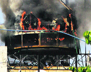 Hotel staff douse the flames after a fire broke out on the terrace of Hotel Sekhon Grand in Jalandhar on Saturday. 