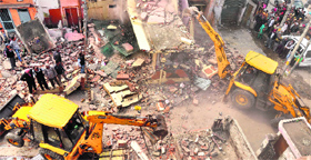 A file photo of earth-moving machines that demolished illegal encroachments at the Jawahar Nagar Camp area in Ludhiana on February 26.