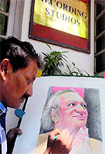 Renowned painter Partha Das gives finishing touches to a painting of sitar legend late Ravi Shankar on the eve of his 94th birth anniversary in Kolkata on Saturday