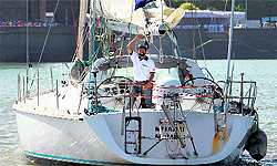 Lt. Cdr Abhilash Tommy waves from INSV Mhadei as he enters the Mumbai harbour on Saturday