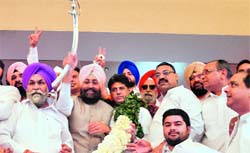 Supporters welcome PPCC president Partap Singh Bajwa in Ludhiana on Saturday. Union Minister Manish Tewari is also seen in the picture. photo: inderjeet verma