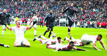 Bayern Munichs players celebrate after winning the German first division Bundesliga title for the 22nd time after a 1-0 win over Eintracht Frankfurt on Saturday. 