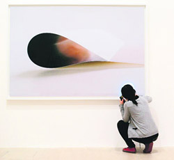 A museum worker checks a photography by German artist Wolfgang Tillmans at the K21 Kunstsammlung Nordrhein-Westfalen museum in Duesseldorf, western Germany. The K21 has organised a solo exhibition of works by Turner Prize winner Wolfgang Tillmans from March 2 to July 7, 2013. The artist has displayed his extensive and many-sided oeuvre, consisting of photographs, abstract paintings, table installations, videos, and artist’s books.