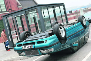 A car laying upside down, work by German artist Hans-Peter Feldmann, is seen in front of the Deichtorhallen museum in Hamburg, northern Germany. From March 1 to June 2, 2013, the museum has presented installations, sculptures and paintings of the conceptual artist.