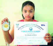 Tennis player Alisha Menon with her certificate and medal in Amritsar on Sunday.