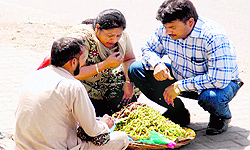 A couple tastes mulberry before buying it in Bathinda on Sunday