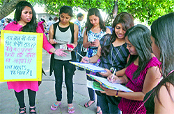 Students during a signature campaign against the four-year degree programme at Delhi University, at Dilli Haat in New Delhi on Sunday