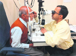 Dr Saurav Luthra, an eye specialist, tests the eyes of a patient at a free health camp organised by the Art of Living for diabetes patient on World Health Day in Dehradun on Sunday.