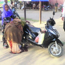 Woman delivers a baby outside the General Hospital, Fatehabad, on Sunday.