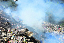 The burning of plastic emits smoke at the solid waste management site of the Dharamsala Municipal Council.