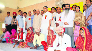 Couples at an annual mass marriage function organised by the Public Social Welfare Council in Ludhiana on Sunday. 