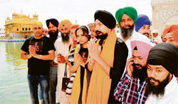 Sadda Haq producer Kuljinder Singh Sidhu (with siropa) and his film team members at the Golden Temple in Amritsar on Sunday.