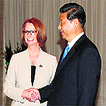 Chinese President Xi Jinping (R) with Australia's PM Julia Gillard in Boao, Hainan province, on Sunday