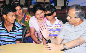 Rohan Pandey (left) and Piyush, whose vision was restored. Rotary Club's former president RK Saboo (right) also seen in the picture. 