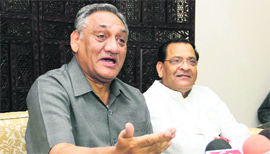 Chief Minister Vijay Bahuguna and Uttarakhand Congress chief Yashpal Arya address a press conference in Dehradun on Monday.