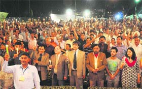People hold  burning candles for world peace in Karnal on Monday