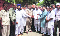 Residents of Kalyanpur village meet rural police officials in Jalandhar on Monday. 