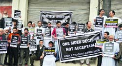 Shopkeepers hold placards during a protest in Srinagar on Monday. Stakeholders claimed their talks failed with the authorities. Photo: Yawar Kabli