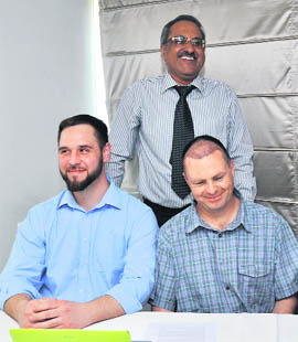 Dr Tejinder Bhatti (standing) with his patients