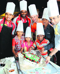 Kings XI Punjab players Bhargav Bhatt, Dimitri Mascarenhas and David Hussey with underprivileged children at a hotel