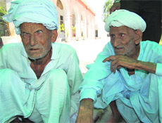 Two migrants from Pakistan, Chunni Lal and Babu Ram, both around 85, talk about their lives in Ambala on Tuesday. 