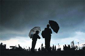 Small pleasures: People enjoy a walk under dark clouds in Shimla
