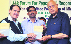 Union Minister Dr Farooq Abdullah releases a book in Jammu on Tuesday.