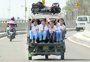As the strike of auto-rickshaw drivers at St Joseph's Convent School ended on Tuesday, students ride back home in an overloaded auto in Jalandhar on Tuesday.