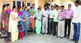 Teachers and the Principal of MGMN Senior Secondary School with copies of Abraham Lincolns letter.
