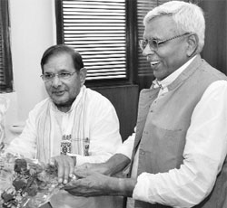 Sharad Yadav with JD(U) leader Shivanand Tiwari after filing nomination papers for the post of party president in New Delhi on Tuesday. 