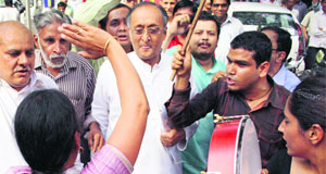 West Bengal Finance Minister Amit Mitra (centre) being roughed up by activists of the SFI and Left parties at Yojna Bhawan in New Delhi on Tuesday. They were protesting against the death of SFI leader Sudipta Gupta in police custody. 