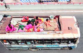 Safety concerns: Throwing norms to the winds, people travel sitting on the roof of a bus in Amritsar on Wednesday