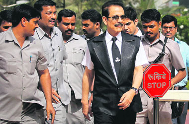 Sahara Group chairman Subrata Roy accompanied by his security leaves the SEBI headquarters in Mumbai on Wednesday. The capital markets regulator had asked Roy to appear before it on April 10 to provide details of his personal assets and the assets of two Sahara companies that sold bonds ruled to be illegal. 