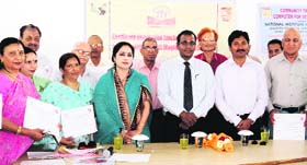 Senior citizens, who have completed their computer training, with Dehradun District Magistrate BVRC Purushottam in Dehradun on Wednesday