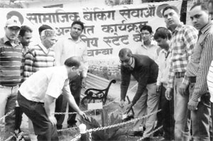 SBI Chief General Manager NK Chari plants a sapling on the SBI premises in Chamba