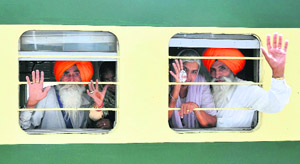 Sikh pilgrims leave for Pakistan in a special train at the Attari railway station on Wednesday.