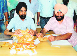 A team of the mobile wing of the Excise and Taxation Department shows the gold jewellery seized from a passenger travelling in the Pashchim Express in Amritsar on Thursday.