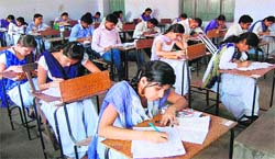 Girls students take B.Com exam being conducted by Hemwati Nandan Bahuguna Garhwal Central University at SMJN College in Haridwar on Thursday. Tribune photo: Rameshwar Gaur