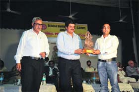 Sanjeev Kaushal, Principal Secretary (Finance), Haryana, gives away a prize to a student at SD College Ambala Cantt during an annual prize distribution function