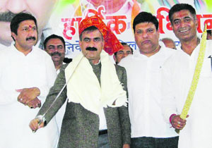 Party workers felicitate Sukhvinder Singh at Una on Thursday. 