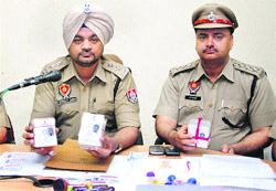 Policemen show fake voter ID cards in Jalandhar on Thursday. 