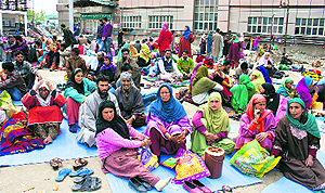 Patients relatives rest in the courtyard of a government maternity hospital in Srinagar.
