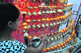 A girl lights lamps at Geeta Mata Mandir at Vikas Nagar in Ludhiana on the occasion of the first Navratra on Thursday.