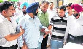 DTO Gurtej Singh (blue turban) being taken into custody by Vigilance officials in Moga on Thursday.