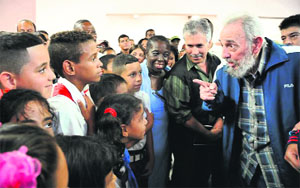 Cuban former leader Fidel Castro interacts with schoolchildren at the inauguration of a school in Havana.