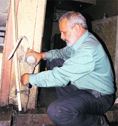 An MC worker disconnects a water connection at the Sector 21 booth market in Chandigarh on Friday. 
