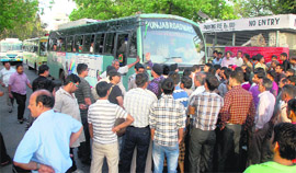 Residents of Uttarakhand protest and block the main gate of the Sector 17 ISBT in Chandigarh on Friday