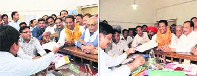 BJP candidate Vinod Chamoli and (right) Congress candidate Suryakant Dhasmana file their nomination papers for the post of Mayor in Dehradun on Friday. 